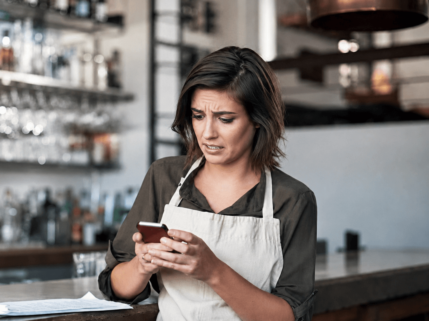 A frontline operator handling requests from her phone